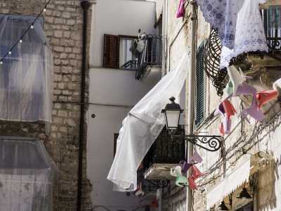 ...mentre sullo slargo si affacciano varie e caratteristiche palazzine coi panni stesi sui balconi...